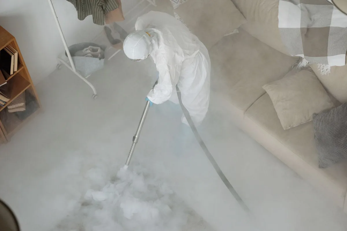 Biohazard cleanup technician in protective equipment, Monticello, AR